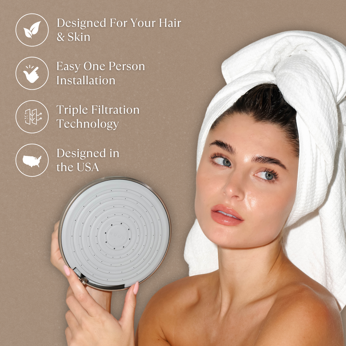 NUUD NO1 filtered showerhead held beside a towel-wrapped hair routine